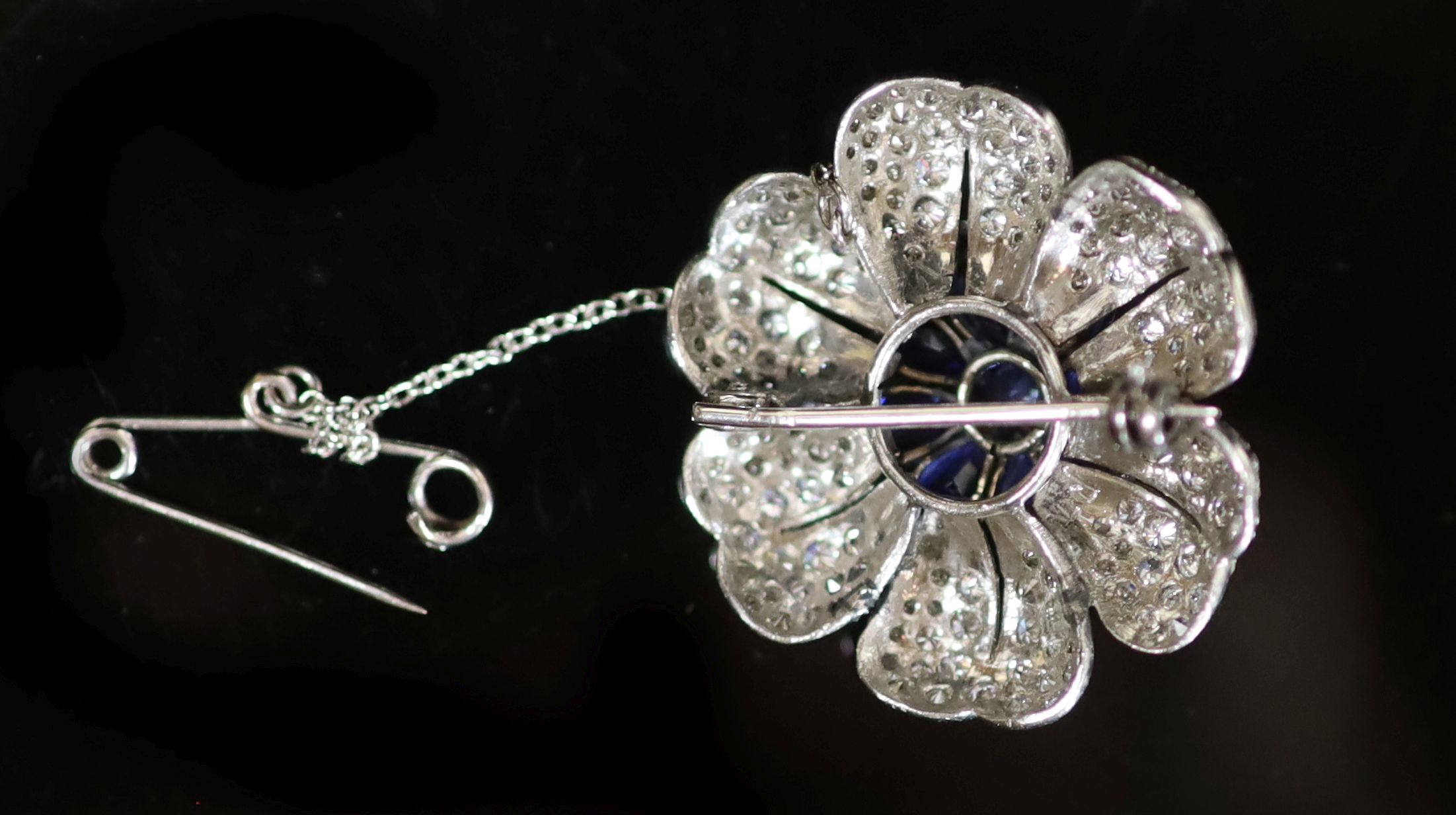 A platinum, sapphire and diamond floral design brooch,